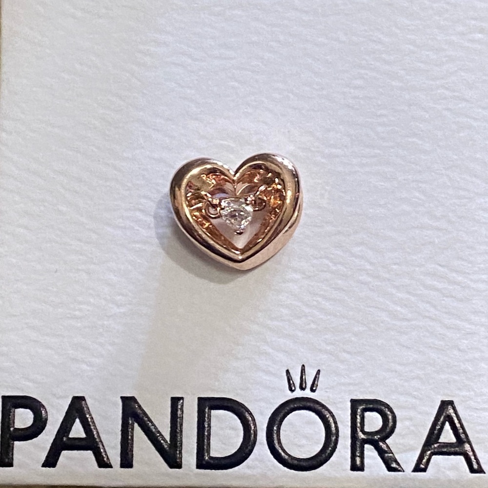 Pandora radiant hearts charm in rose gold pl.